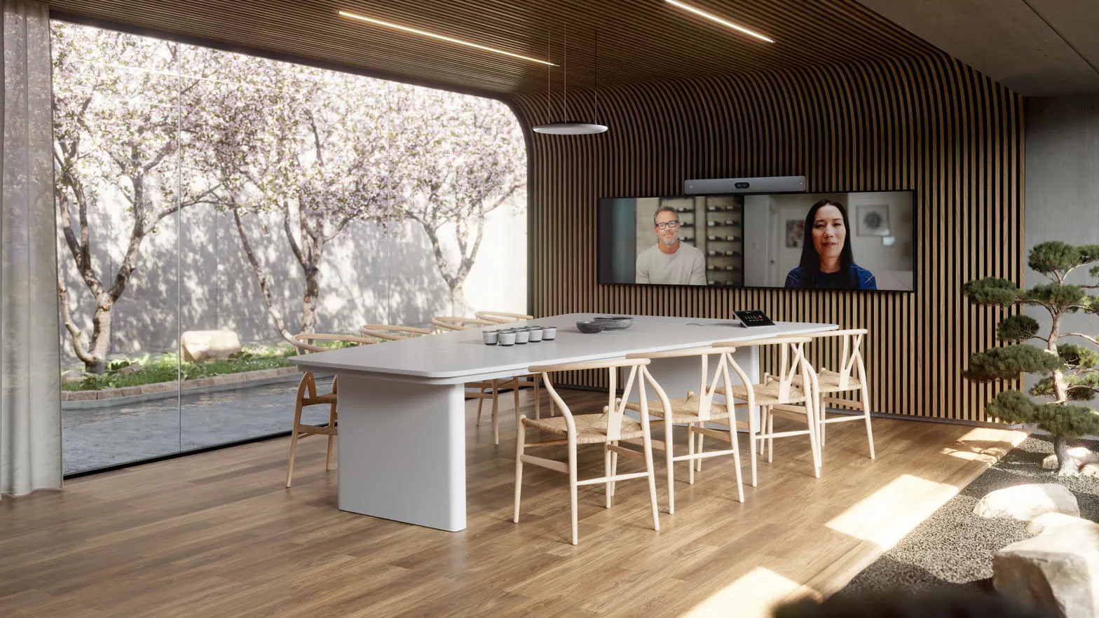 Meeting room with a Cisco video bar, dual displays and a ceiling microphone over the table