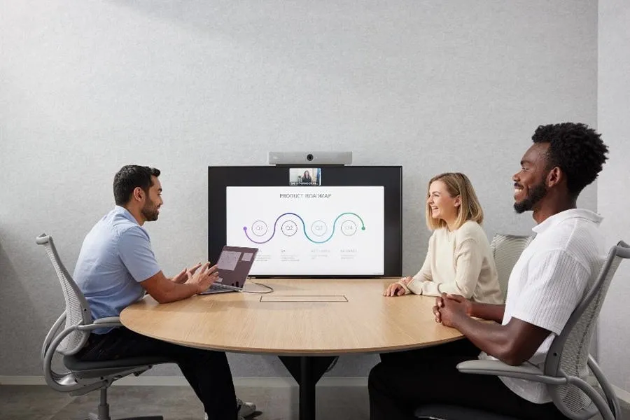 Small meeting room with Cisco Room Bar on a single display and three people at the table