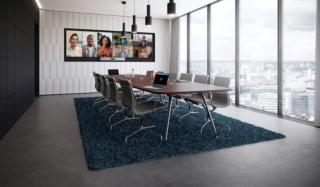 Large conference table facing a Cisco Room Kit EQ Quad Camera and display wall
